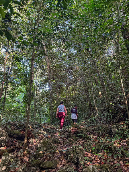 Lina Stock hiking with a guide to ancient village ruins in Ngeremdiu, Palau