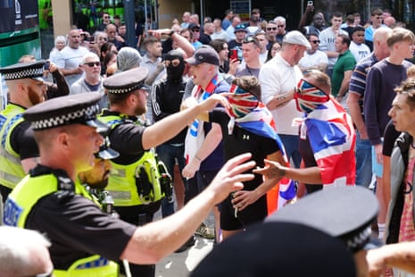 Police place themselves in front of marchers in Leeds city centre.