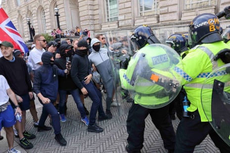 Police officers and demonstrators clash in Liverpool on Saturday.