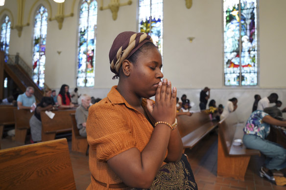 Mary Moret, seorang jemaat di Gereja Katolik St. Raphael, berdoa dalam Misa di Springfield.