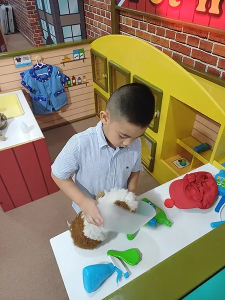 Little boy pretending to be a veterinarian in Kidzooona Robinsons Galleria