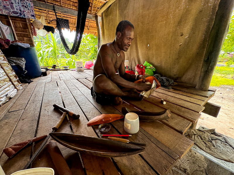 Man working on handicrafts in Haroro Village at Roderick Bay, Solomon Islands
