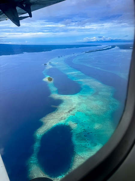 Solomon Islands airplane window view over lagoons