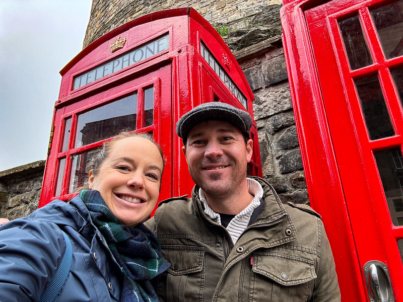 Lina and David Stock in front of red telephone booths during a tour in Great Britain