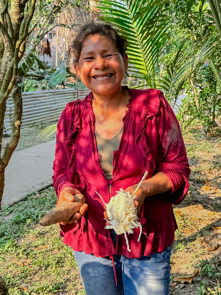 Woman showing tapioca root in a Amazon community near Iquitos, Peru