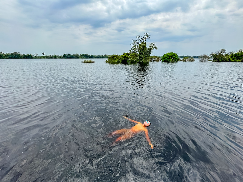 David Stock swiming in the Ucayali River in Iquitos, Peru