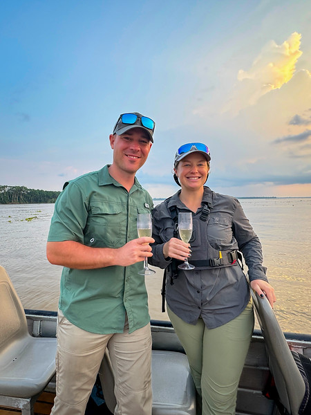 Lina and David Stock toasting to the birth of the Amazon River near Iquitos, Peru