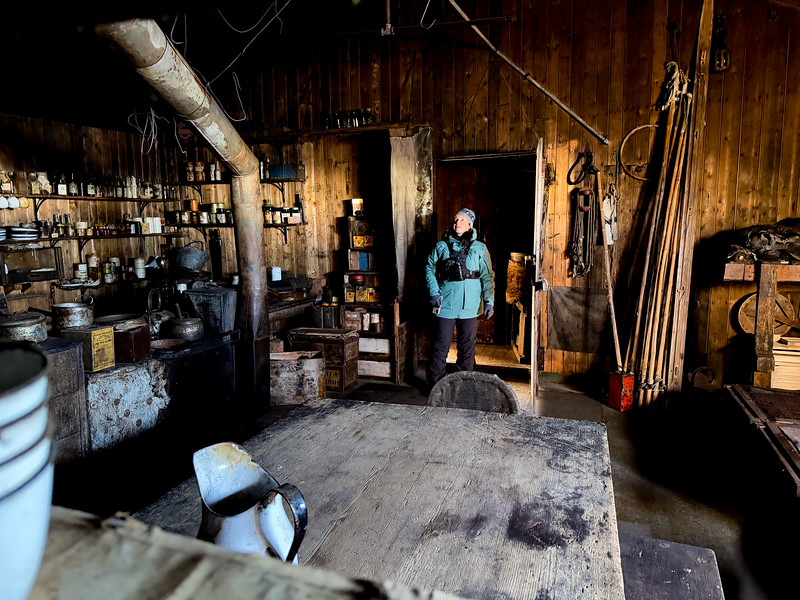 Lina Stock standing inside of Scott's Terra Nova Hut at Cape Evans, Ross Sea, Antarctica
