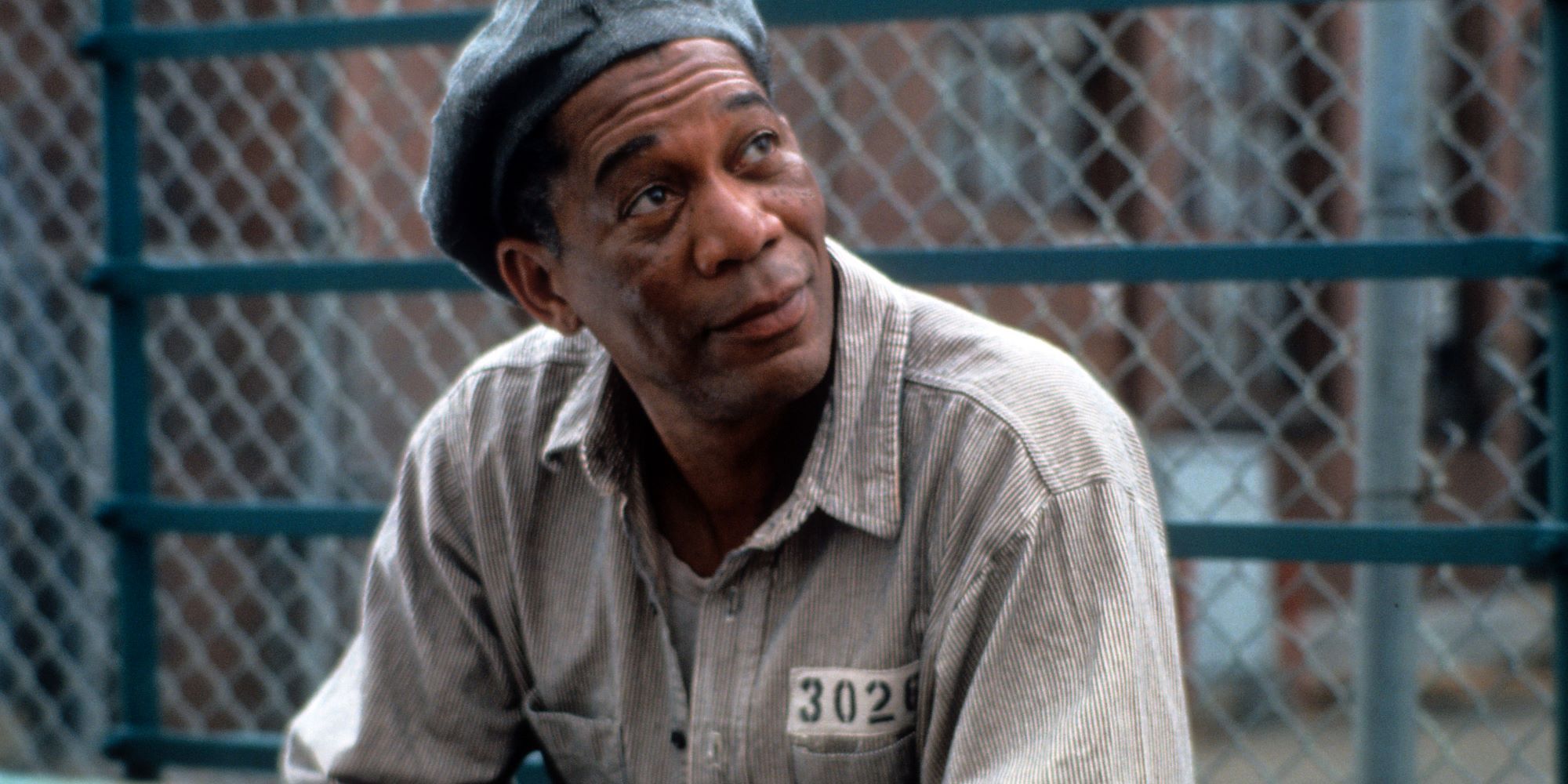 Red crouching and looking up at someone in The Shawshank Redemption