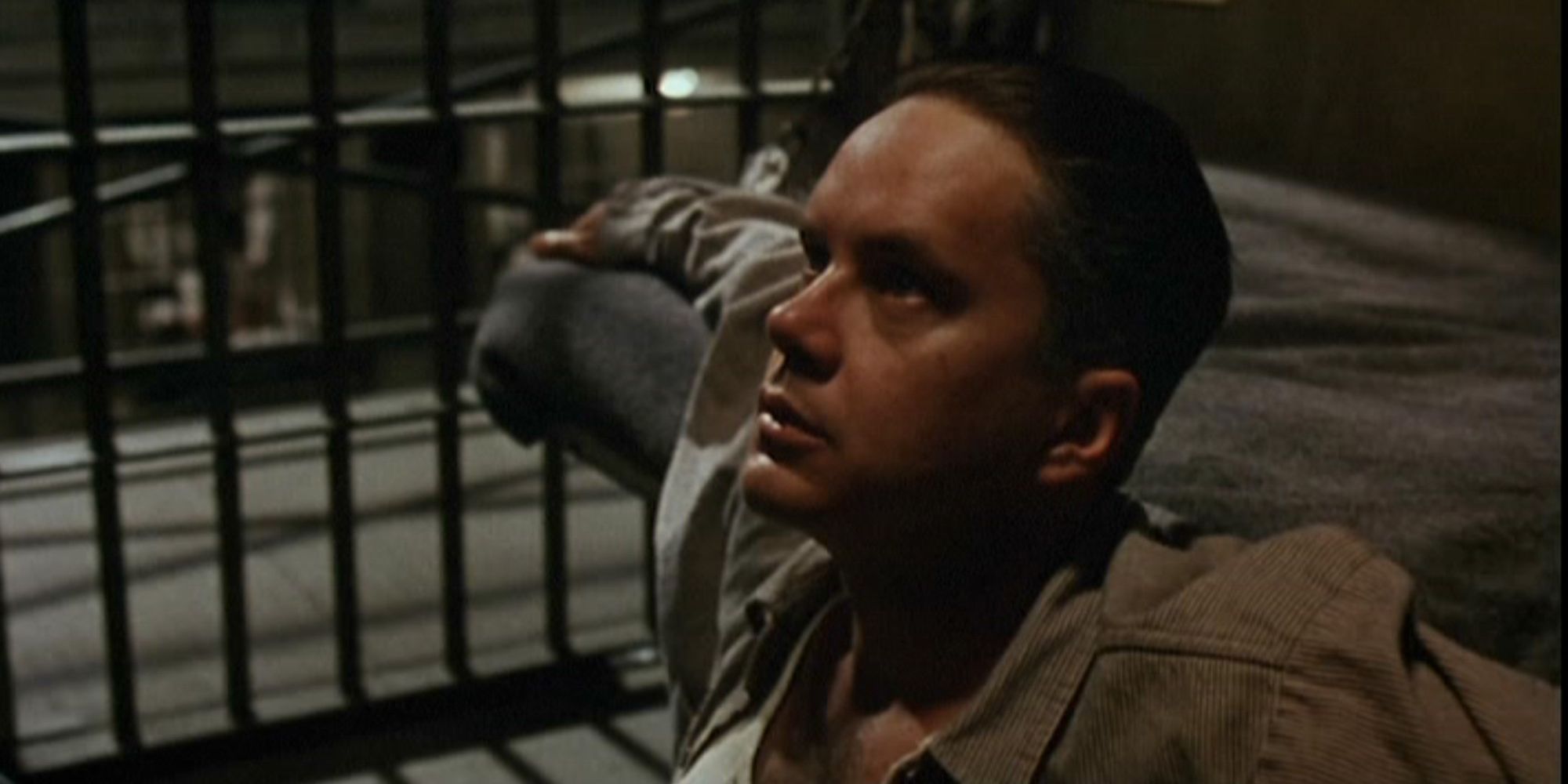 Andy Dufresne sitting in his cell looking up in The Shawshank Redemption