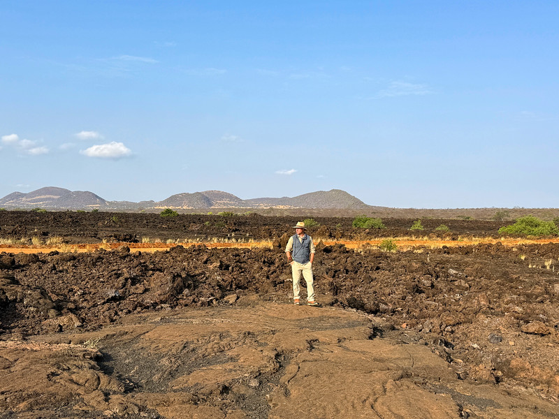 David Stock walking on a lava field in Tsavo West National Park, Kenya