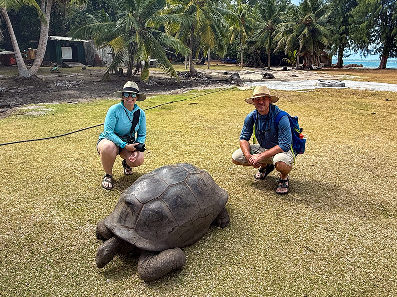 Lina and David Stock with Aldabra Giant Tortoise on Curieuse Island, Seychelles