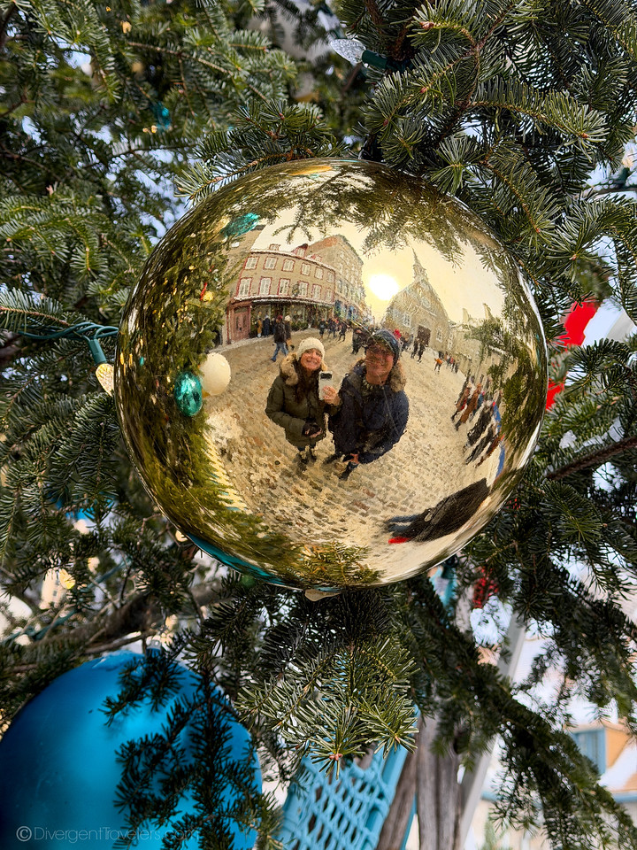 Lina and David Stock looking into a Christmas tree ornament in Quebec City